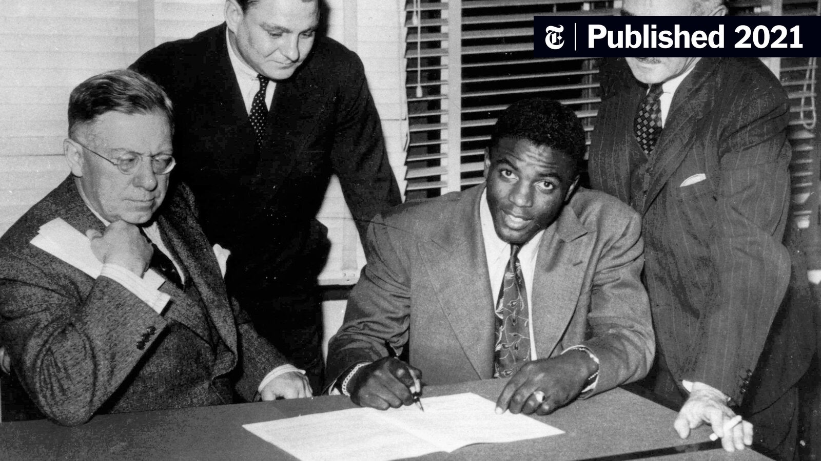 Photo of Jackie Robinson Signing Contract: Rare Glimpse of a Baseball Legends Historic Moment